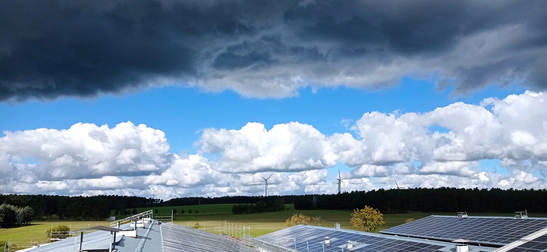 A-G-BAU rooftop solar project beneath a dramatic cloudscape